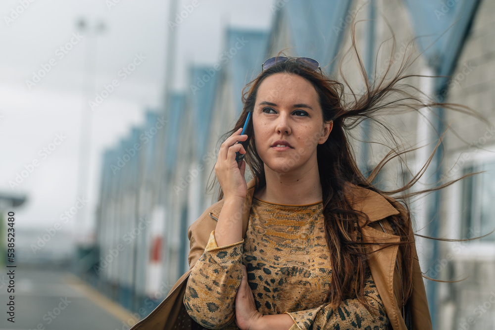 young woman with autumn clothes and mobile phone on the street young woman with autumn clothes and mobile phone on the street