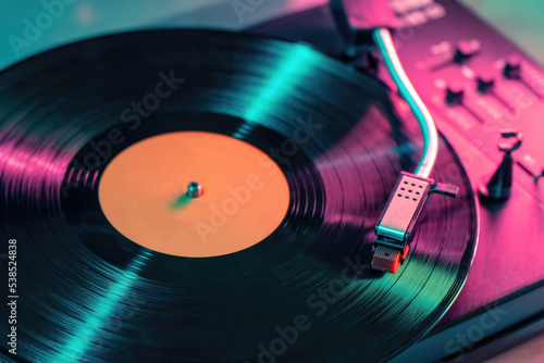 View on vintage vinyl record player playing sound from LP album. photo