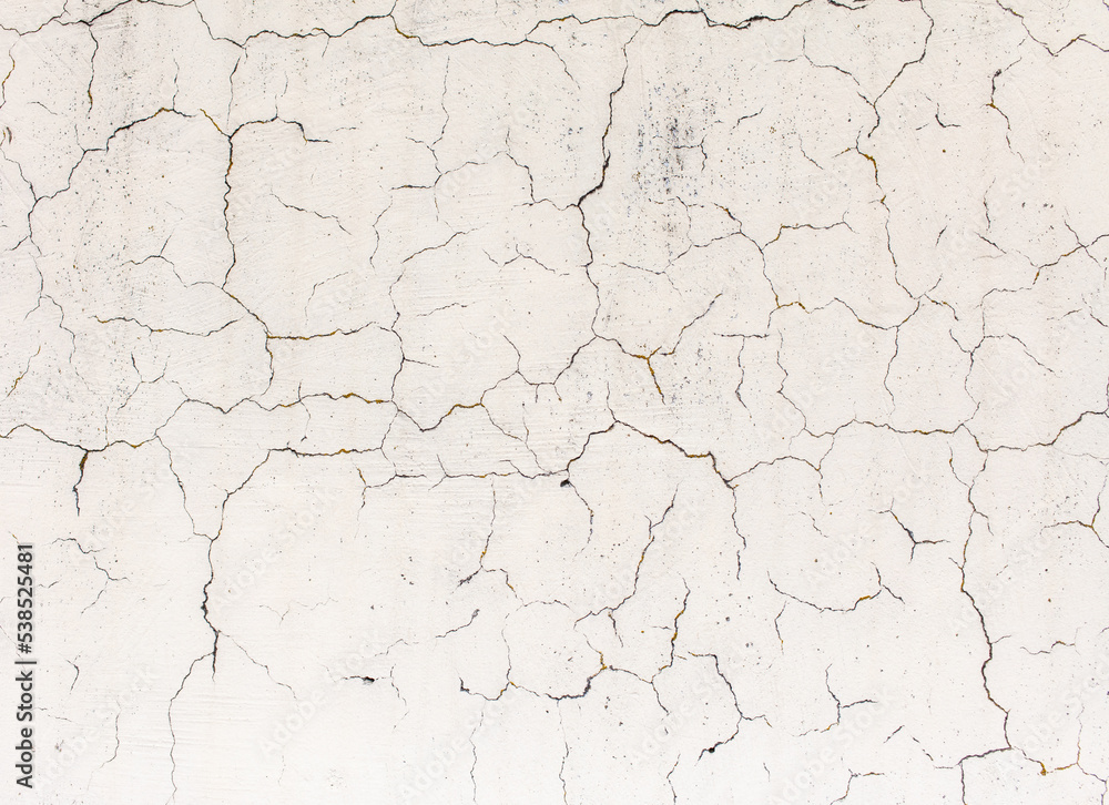 Cracked plaster on the wall of the house. Cracked plaster on the wall of the house.