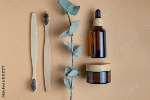 personal hygiene kit. Bath and Skin Care Accessories. Daily natural organic bodycare concept, organic bath products. Bamboo Toochbrushes and face cream and serum in dark glass backage with bamboo lid