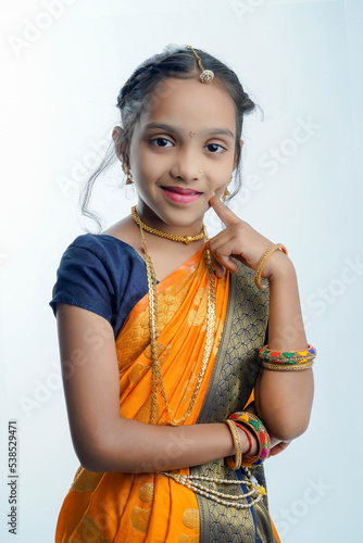 indian marathi little girl in traditional blue navwari saree on white background photo