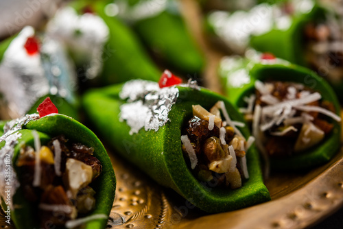 Kaju Gulkand Paan Mithai barfi - Indian sweet or dessert served in a plate photo