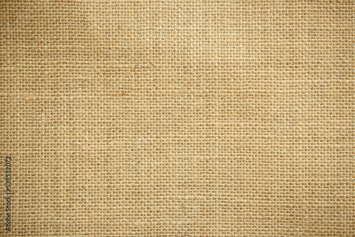Jute hessian sackcloth burlap canvas woven texture background pattern in light beige cream brown color design element.