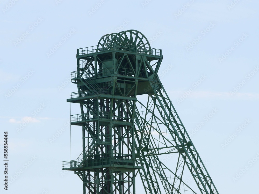 Upper part of a winding tower of a former coal mine on the lower Rhine river.  The steel frame and the huge cable winches with which the cables of the hoisting cage were moved can be seen 