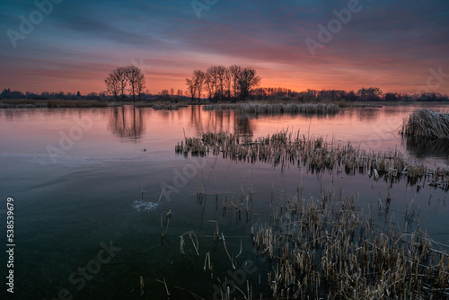 A colorful sunset over a frozen lake