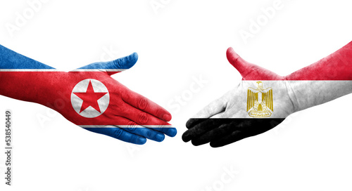 Handshake between Egypt and North Korea flags painted on hands, isolated transparent image.
