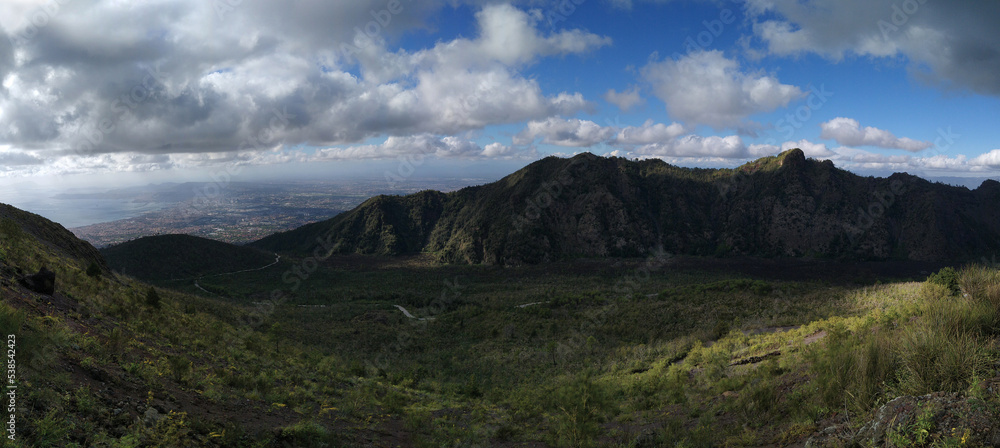 National Park of the Vesubio Volcano. View of the valley with the lava river of the Somma volcano and Naples city in the rear. Campania. Italy.