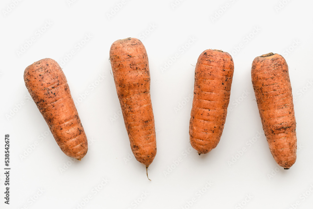 Carrots on a white background. Dirty carrot. Carrots on a white background. Dirty carrot.