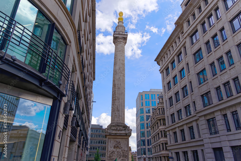 Monument to the Great Fire of London at City of London on a blue cloudy summer day. Photo taken August 1st, 2022, London, United Kingdom.