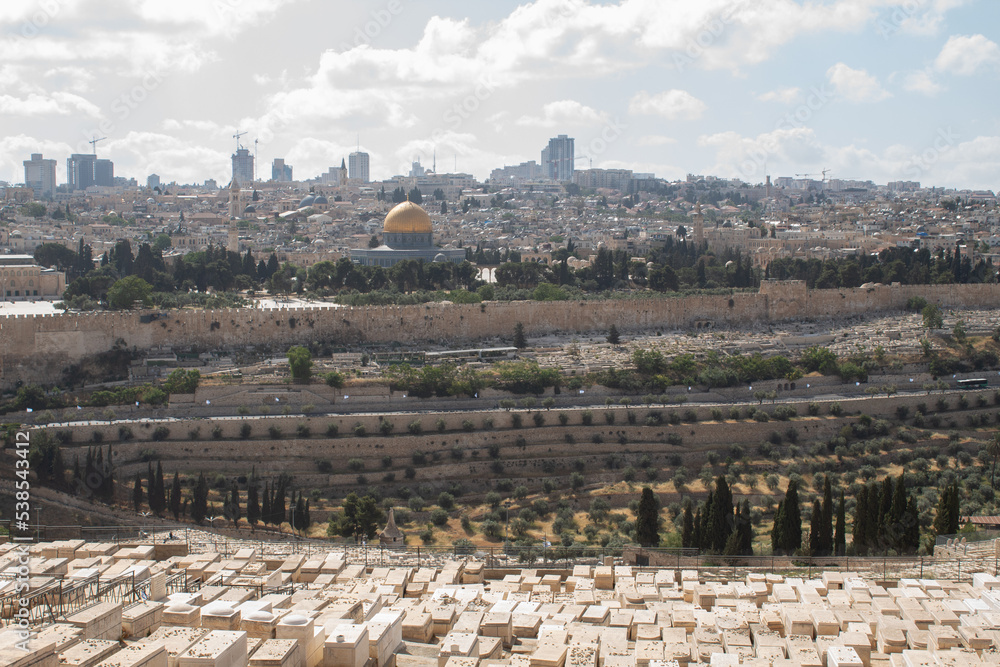 Jerusalem, Israel - May 5th 2022: Jerusalem view from the Mount of Olives. Jewish cemetery pointing at the city of Jerusalem.