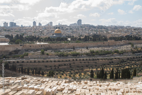 Jerusalem, Israel - May 5th 2022: Jerusalem view from the Mount of Olives. Jewish cemetery pointing at the city of Jerusalem.