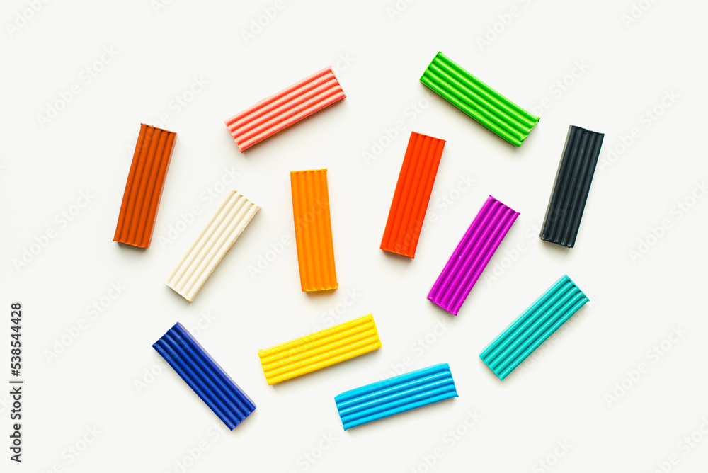 Children's plasticine on a white background. Colored plasticine. Children's plasticine on a white background. Colored plasticine.