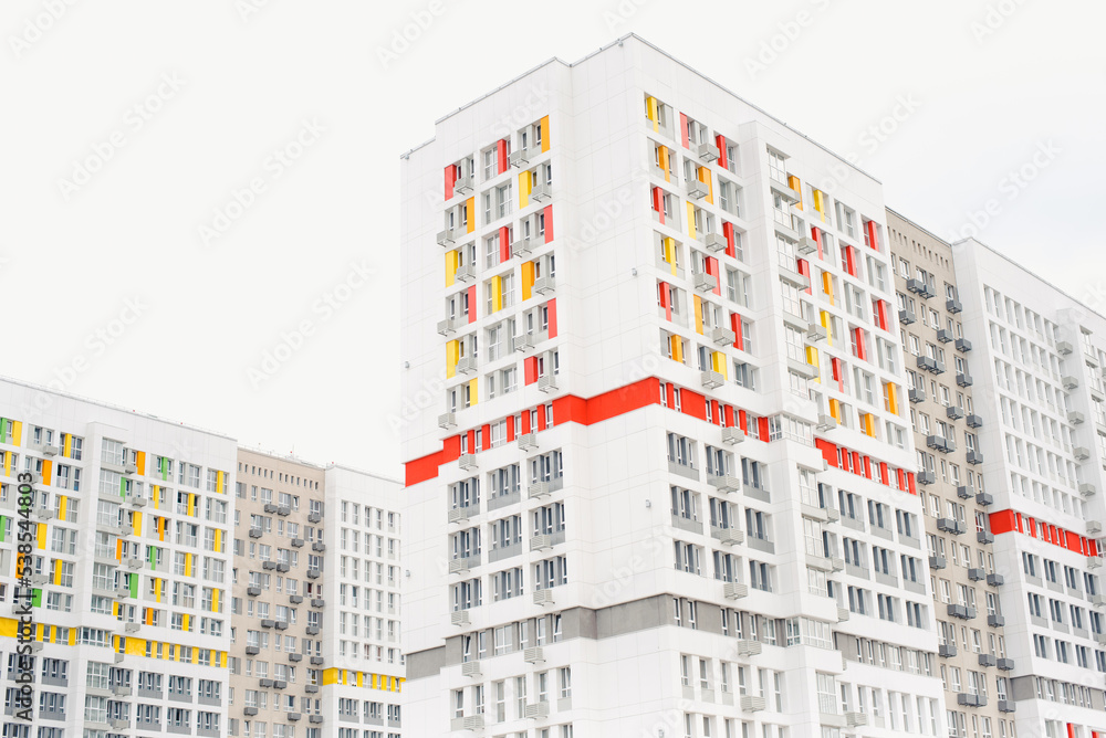 Colored new building. Multi-storey building. Residential quarter.