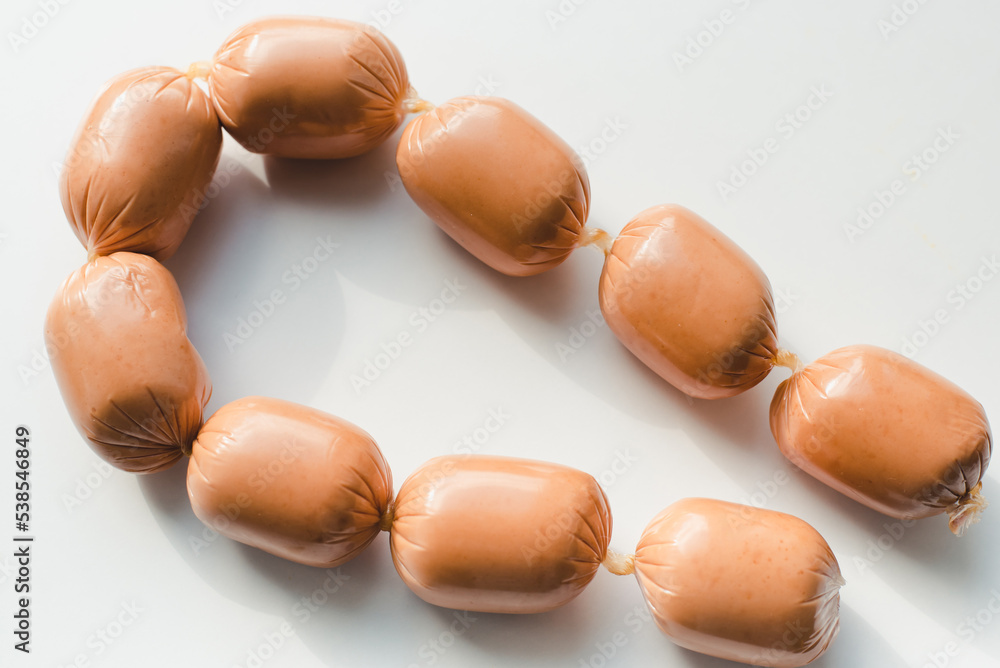 Sausages on a white background. Sausages on a white background. Sausages on a white background. Sausages on a white background.