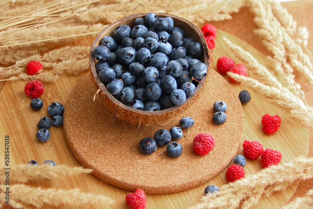 blueberry. blueberries in coconut peel on a wooden table blueberry. blueberries in coconut peel on a wooden table