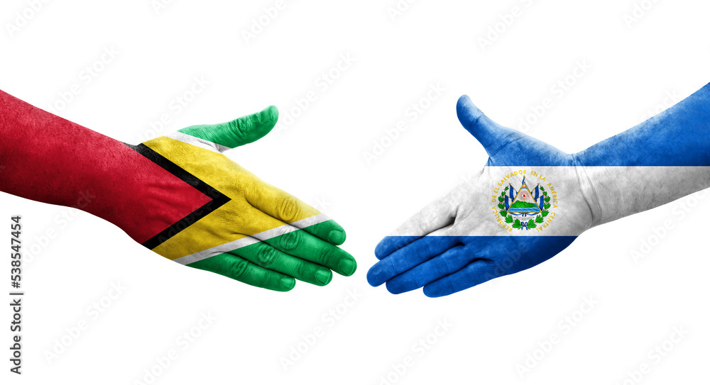 Handshake between El Salvador and Guyana flags painted on hands, isolated transparent image. Handshake between El Salvador and Guyana flags painted on hands, isolated transparent image.