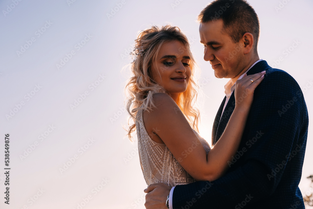 Happy young couple against blue sky, low angle view. Honeymoon trip Happy young couple against blue sky, low angle view. Honeymoon trip