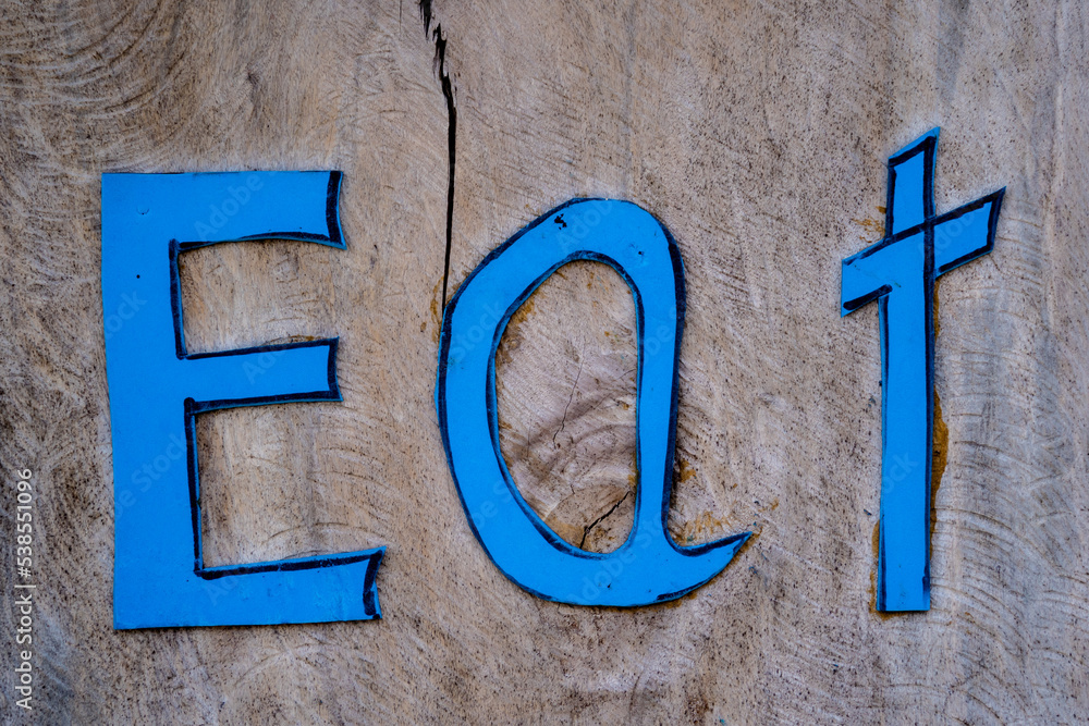 Wooden sign board with eat in tropical cafe Wooden sign board with eat in tropical cafe