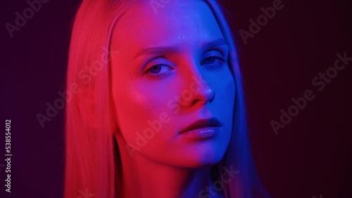 Portrait of a young woman in neon light. Colored light in the club  fashion portrait