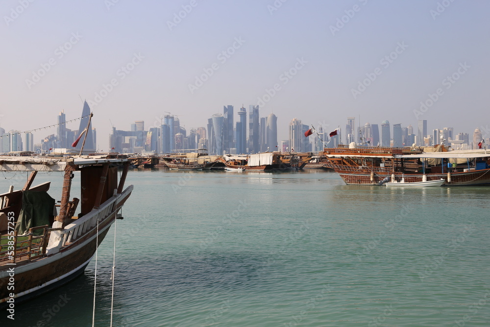 Cityscape with old boats on skyscrapers from the Corniche in Doha, Qatar