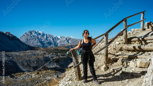 hiker girl standing next to the old fence at tre cime di lavaredo