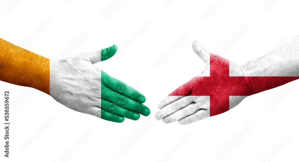 Fototapeta premium Handshake between England and Ivory Coast flags painted on hands, isolated transparent image.