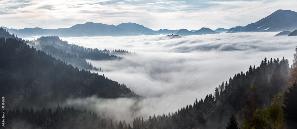 Landscape with high mountains. Panorama view. Fields and meadow are covered with morning fog and dew. Touristic resort Carpathian national park, Ukraine Europe. Natural scenery.