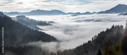 Landscape with high mountains. Panorama view. Fields and meadow are covered with morning fog and dew. Touristic resort Carpathian national park, Ukraine Europe. Natural scenery. © Vitalii_Mamchuk