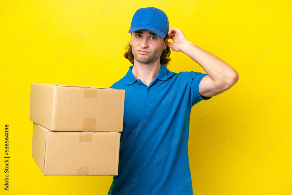 Delivery handsome man isolated on yellow background having doubts Delivery handsome man isolated on yellow background having doubts