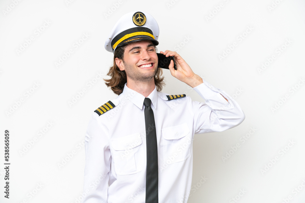 handsome Airplane pilot isolated on white background keeping a conversation with the mobile phone