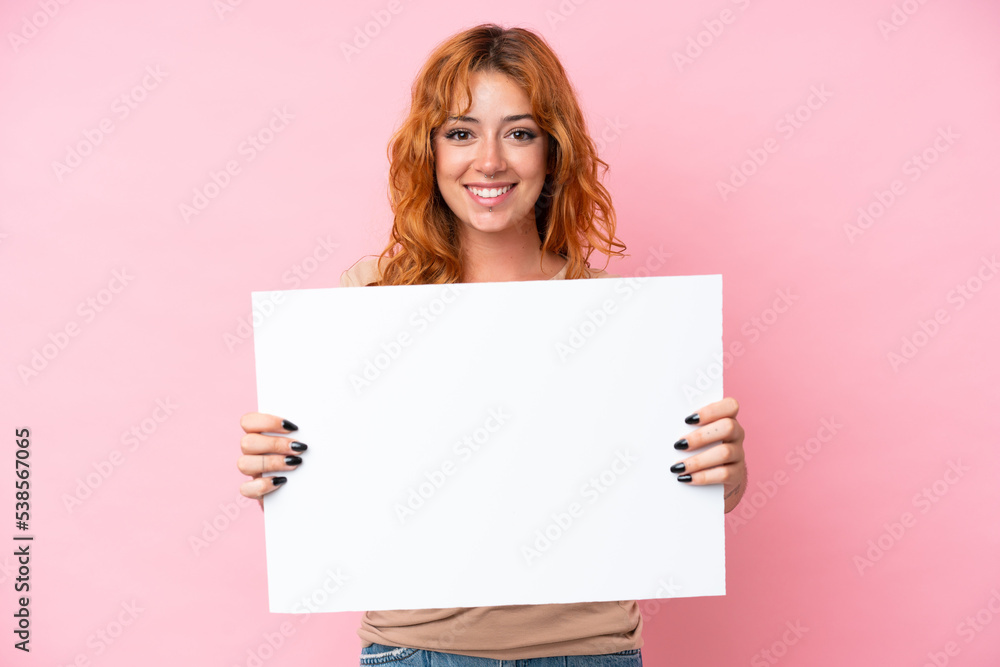 Young caucasian woman isolated on pink background holding an empty placard with happy expression Young caucasian woman isolated on pink background holding an empty placard with happy expression