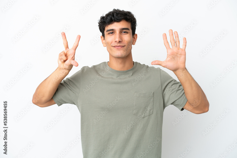 Young Argentinian man isolated on white background counting eight with fingers Young Argentinian man isolated on white background counting eight with fingers