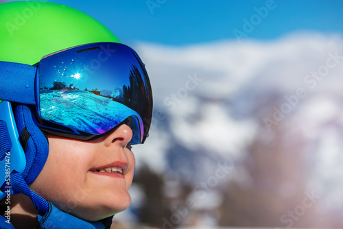 Portrait of a happy smiling boy in ski helmet and mask