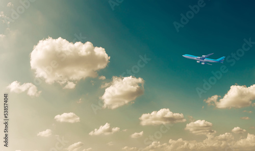 Commercial airplane flying against blue dramatic cloudscape sky. Jet plane in high flight. Airliner flying under the clouds. Aircraft flying in the clouds. 