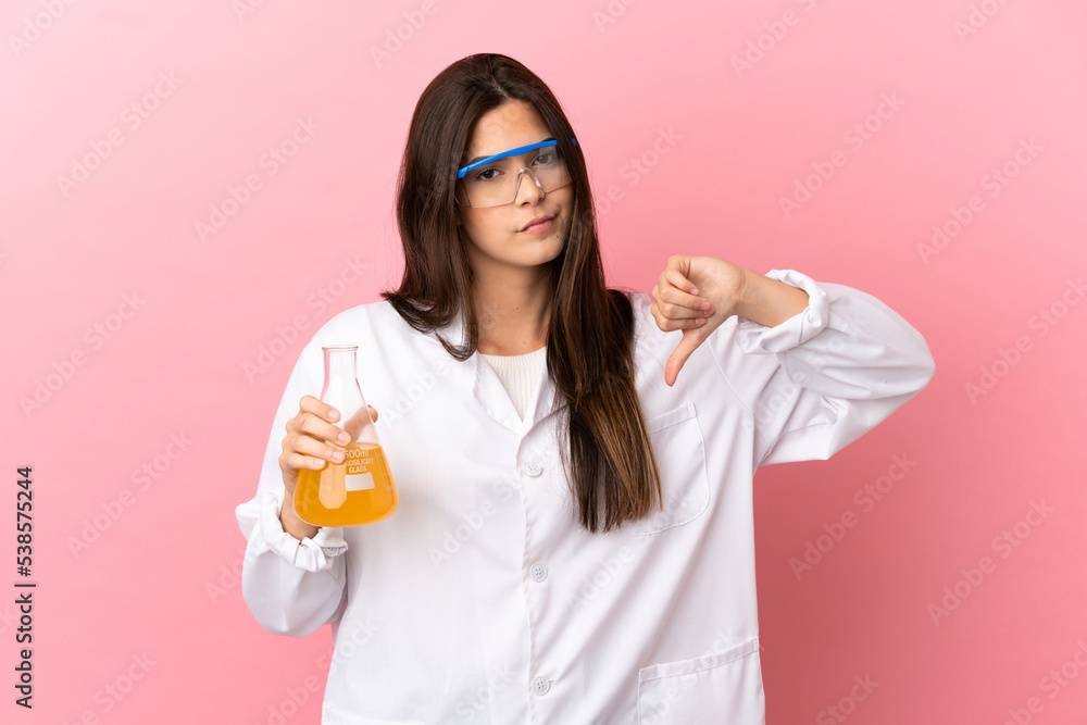 Young scientific girl over isolated pink background showing thumb down with negative expression Young scientific girl over isolated pink background showing thumb down with negative expression
