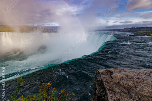 rainbow over waterfall
