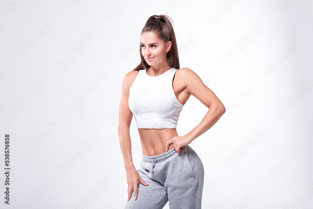 Young white fitness woman wearing sportswear standing over white wall background. Fitness concept Young white fitness woman wearing sportswear standing over white wall background. Fitness concept
