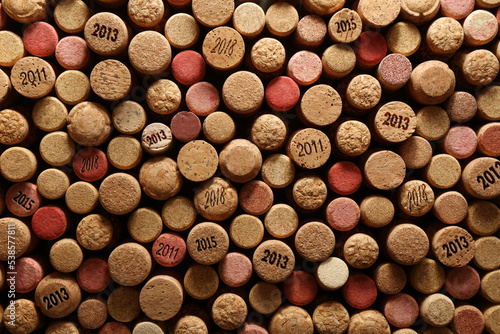 Many wine corks with different dates as background, top view