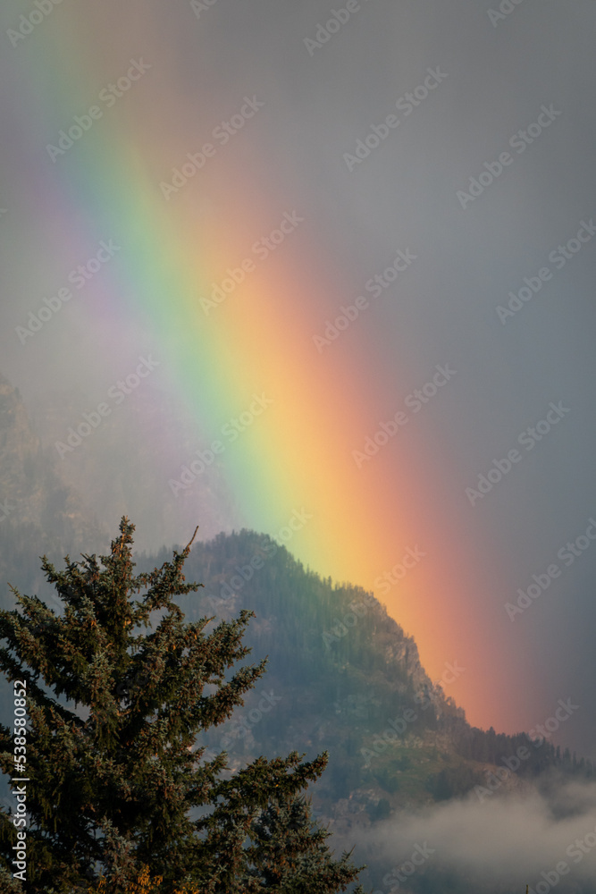 Brilliantly Colored Rainbow Dancing Down a Mountain Ridge in the Teton Range in Wyoming