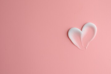 Sample facial cream on pink background, top view. Space for text