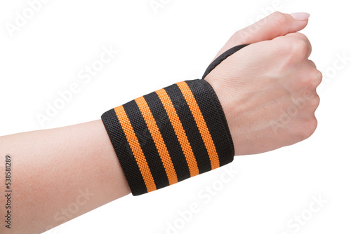 A sports wristband with orange stripes is worn on a female hand clenched into a fist, concept, on a white background, isolate