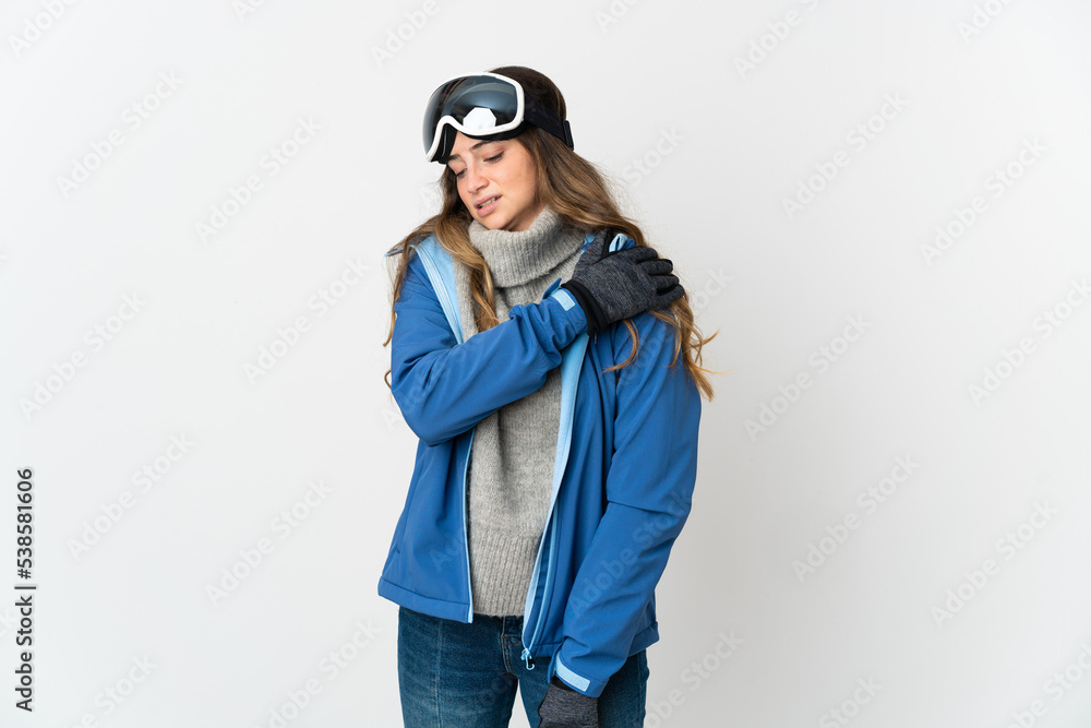 Skier girl with snowboarding glasses isolated on white background suffering from pain in shoulder for having made an effort Skier girl with snowboarding glasses isolated on white background suffering from pain in shoulder for having made an effort
