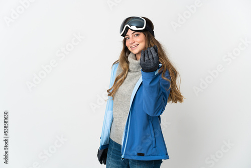 Skier girl with snowboarding glasses isolated on white background making money gesture