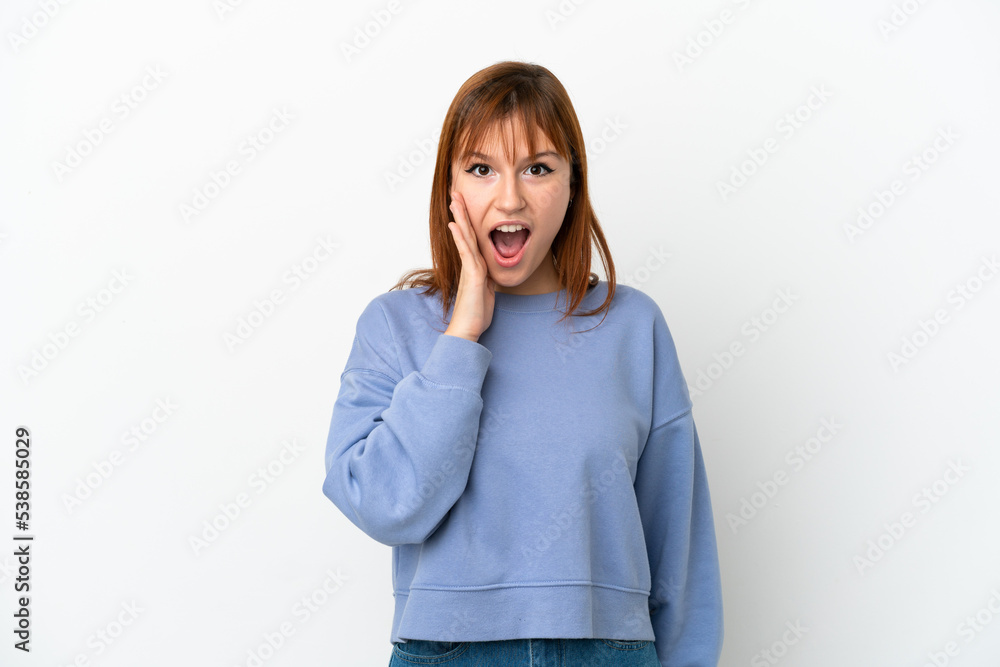 Redhead girl isolated on white background with surprise and shocked facial expression Redhead girl isolated on white background with surprise and shocked facial expression