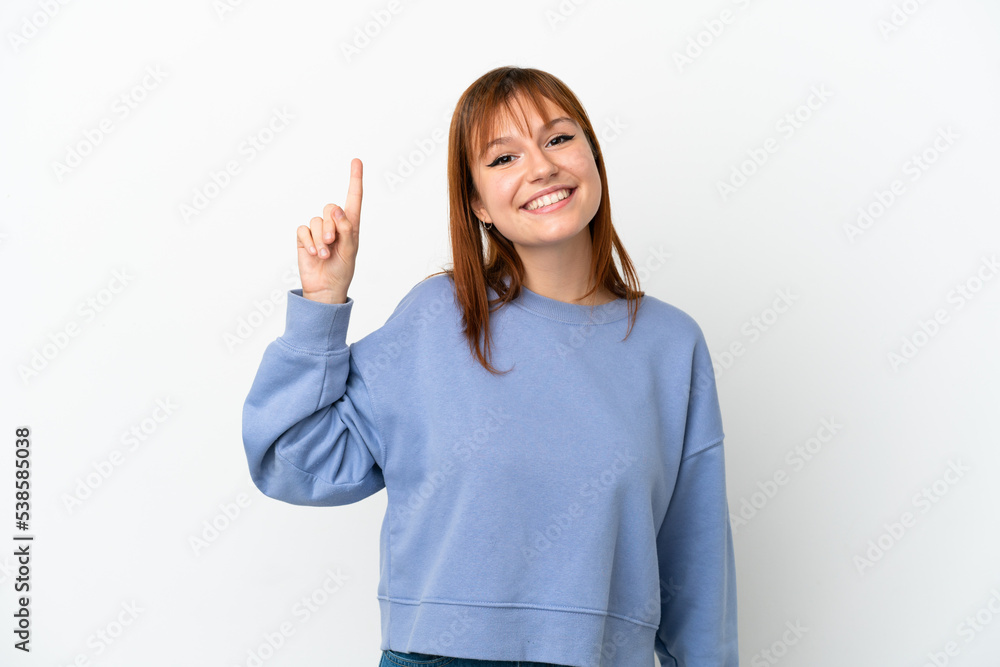 Redhead girl isolated on white background showing and lifting a finger in sign of the best Redhead girl isolated on white background showing and lifting a finger in sign of the best