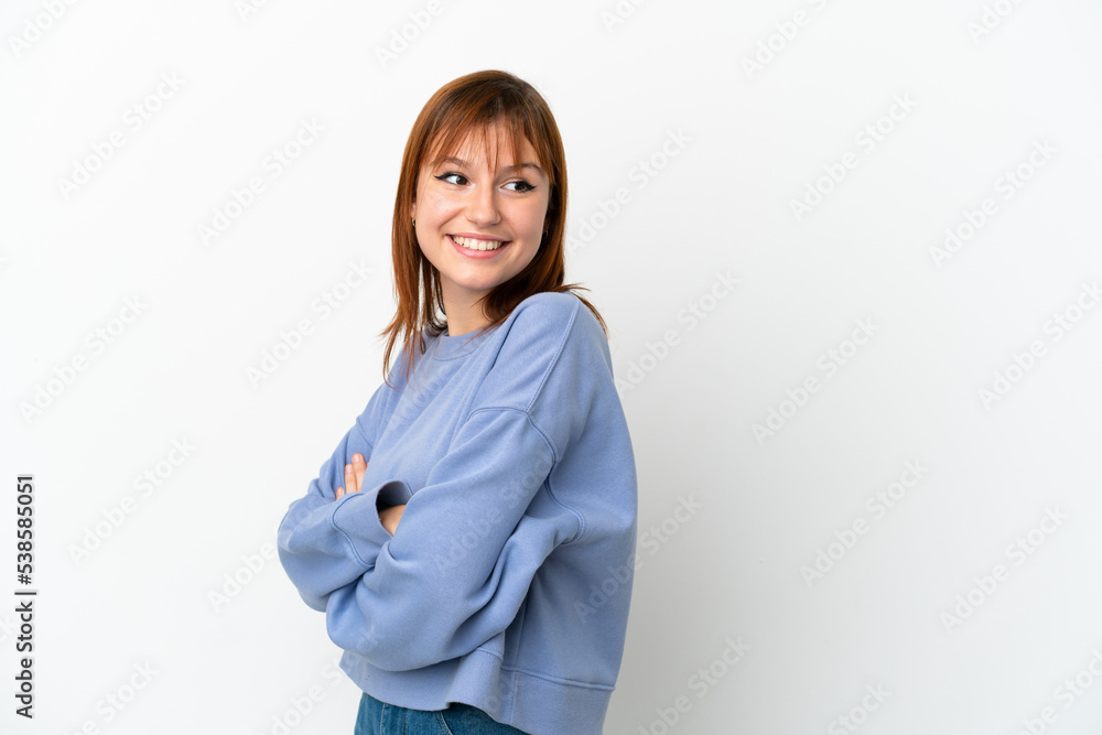 Redhead girl isolated on white background with arms crossed and happy Redhead girl isolated on white background with arms crossed and happy