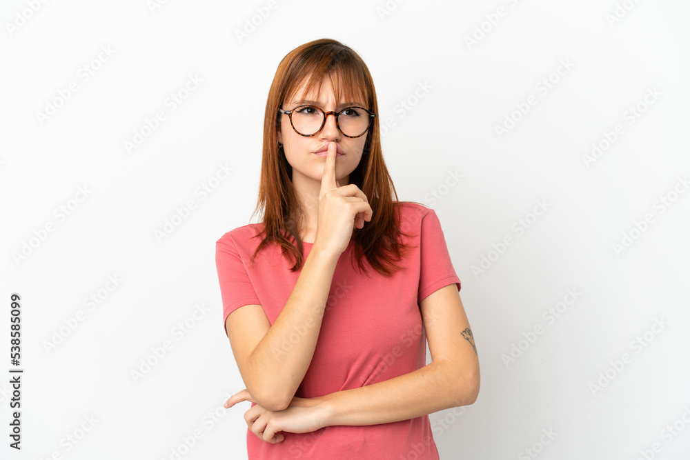 Redhead girl isolated on white background having doubts while looking up