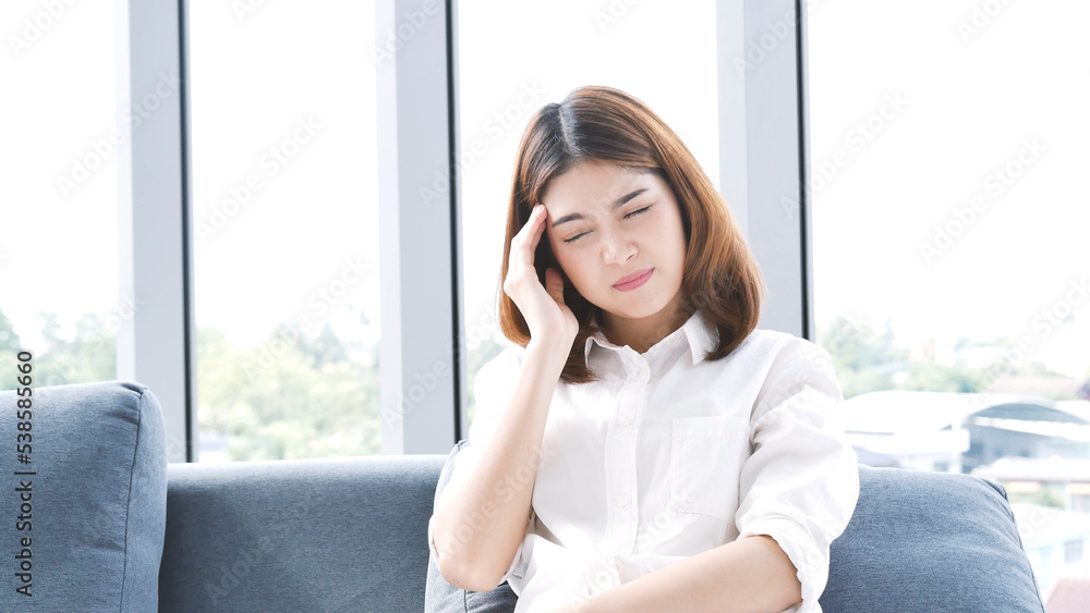 Stress asian women headache have migraine feeling temples stressfull upset depressed. Strong headache migraine exhausted young girl. Office syndrome unhealthy Tension person. Woman headache concept Stress asian women headache have migraine feeling temples stressfull upset depressed. Strong headache migraine exhausted young girl. Office syndrome unhealthy Tension person. Woman headache concept