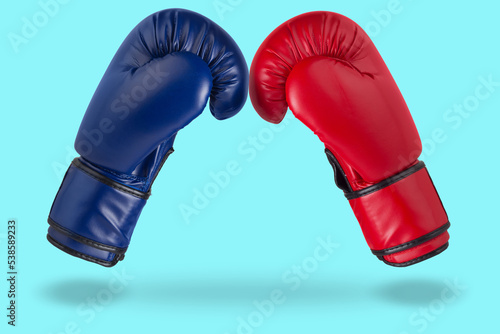 Two boxing gloves, blue and red, as if levitating, touching with fingers, leadership