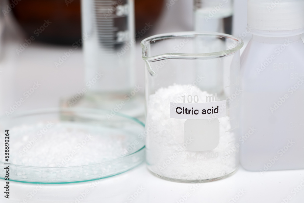 Citric acid in glass, chemical in the laboratory and industry Citric acid in glass, chemical in the laboratory and industry